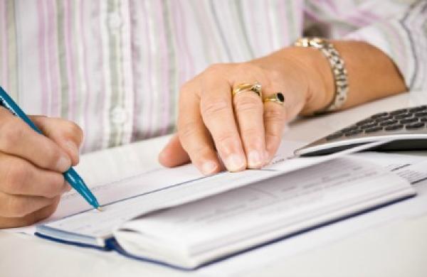 2016-06-julie-segal-longevity-senior-woman-writing-checks-large.jpg