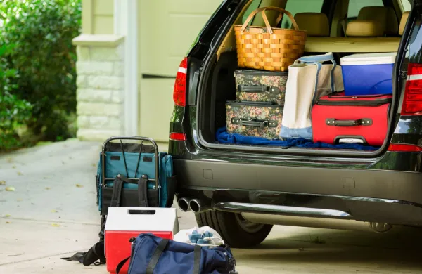 Family vehicle packed, ready for road trip, vacation outside home.