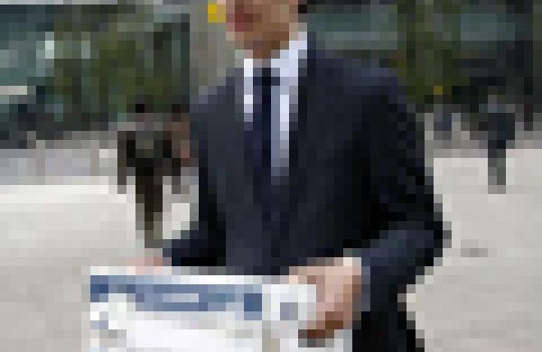 A Lehman Brothers employee carries a box away from the office of the U.S. investment bank in London