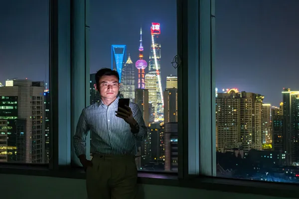 Man in front of a city skyline at night