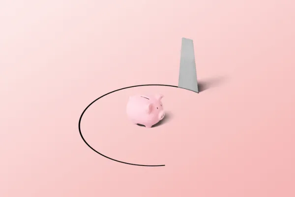 A pink piggy bank resting inside a chalk circle on a pink background.