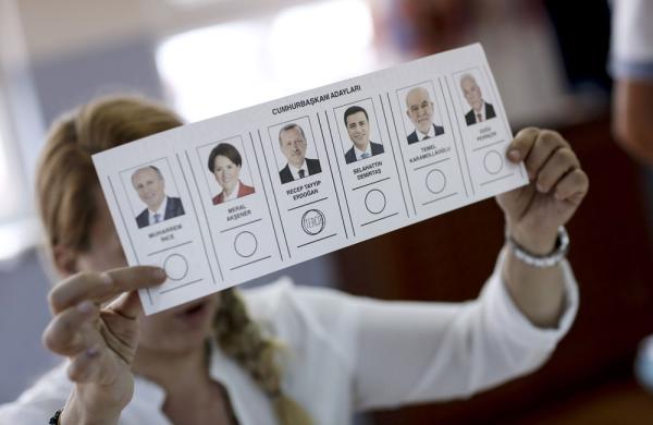 An election official displays a ballot in Turkey during last month's vote. (Kostas Tsironis/Bloomberg)