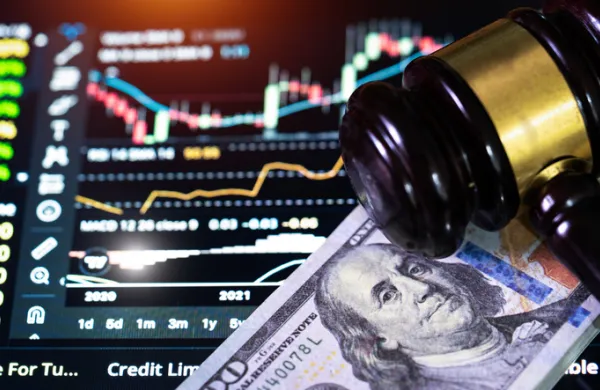 Investment concept,US paper currency on Laptop and gavel,Money with a hammer.