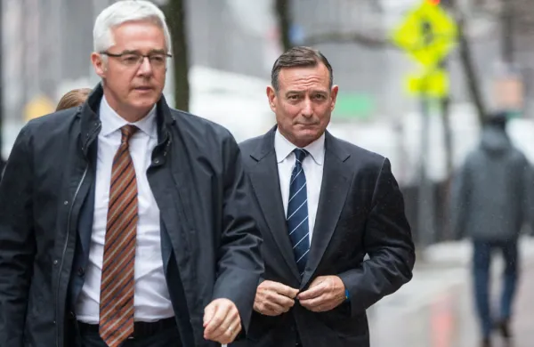 Douglas Hodge, right, enters federal court in Boston, Massachusetts on Feb. 7, 2020. (Scott Eisen/Bloomberg)