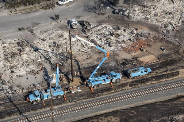 Pacific Gas & Electric Co. employees work to fix downed power lines burned by wildfires in this aerial photograph taken above Santa Rosa, California (David Paul Morris/Bloomberg)