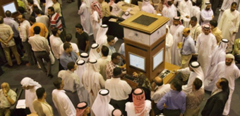 Investors at the Dubai Financial Market, the local Stock Exchange, gather round the display showing the latest prices. Dubai. United Arab Emirates. Investors at the Dubai Financial Market, the local Stock Exchange, gather round the display showing the latest prices. Dubai. United Arab Emirates.