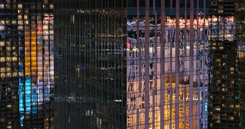 Drone View of Skyscrapers Reflecting Las Vegas Buildings at Night - stock photo