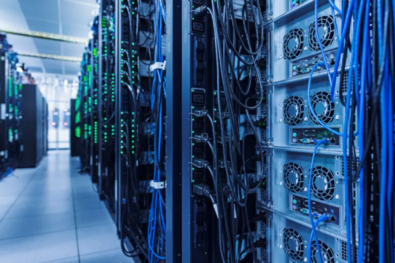 Server racks with blue and green cables in a data center.