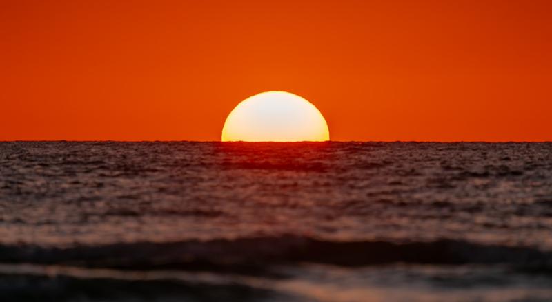 Scenic view of sea against orange sky,Indian Rocks Beach,Florida,United States,USA