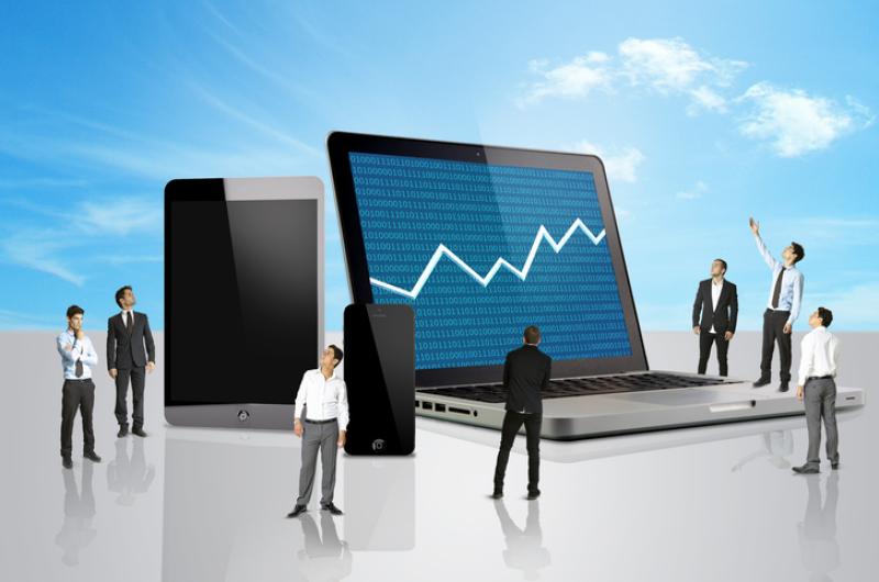 Group of men looking at a laptop with stocks mark Group of men looking at a laptop with stocks mark