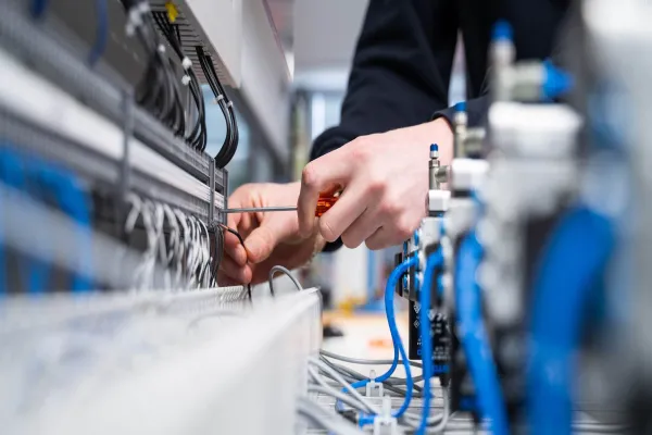 Detail of electrician using equipment in shop
